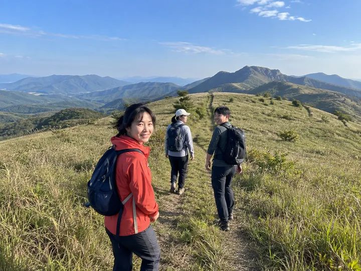 Friends walking along a mountain trail.